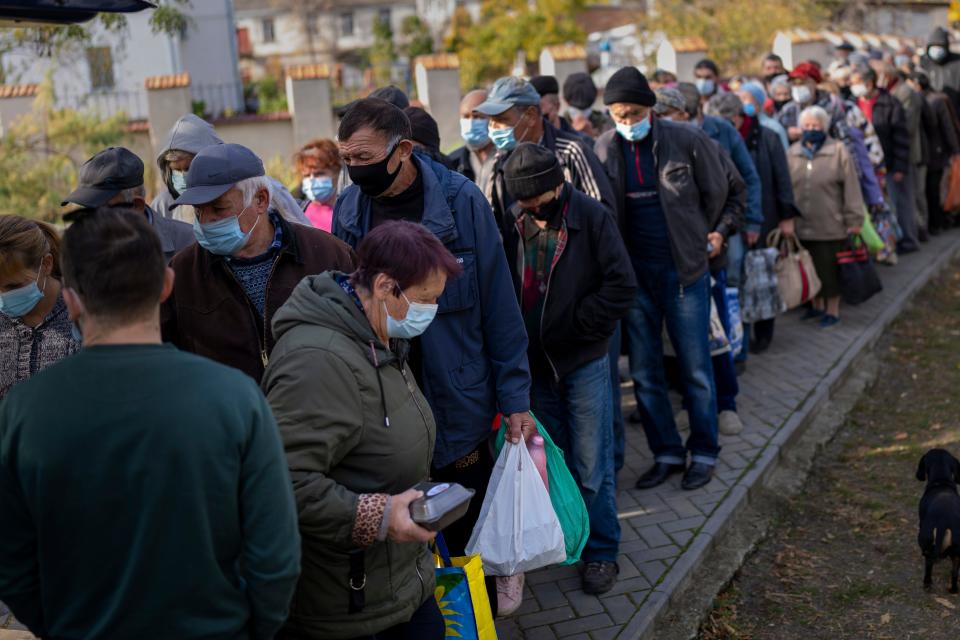 People queue up to wait for food from the World Central Kitchen organization in the center of Mykolaiv, Ukraine, on Monday.