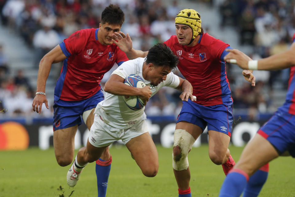 England's Marcus Smith dives with the ball during the Rugby World Cup Pool D match between England and Chile at the Stade Pierre Mauroy in Villeneuve-d'Ascq, outside Lille, Saturday, Sept. 23, 2023. (AP Photo/Michel Spingler)