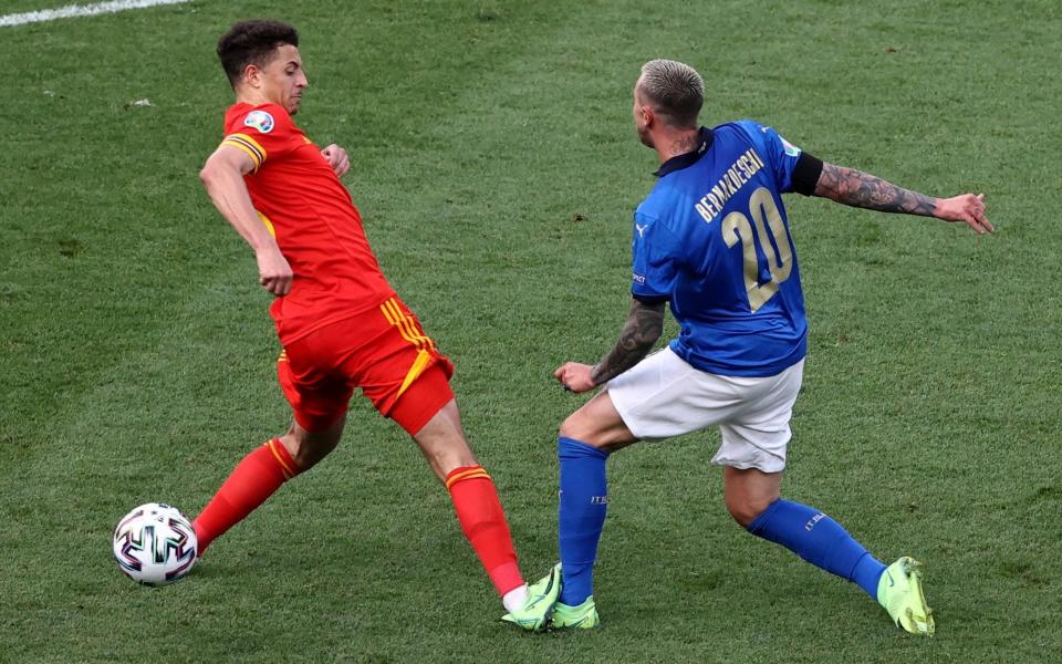 Italy's Federico Bernardeschi, right is fouled by Wales' Ethan Ampadu, who was sent off for this - AP