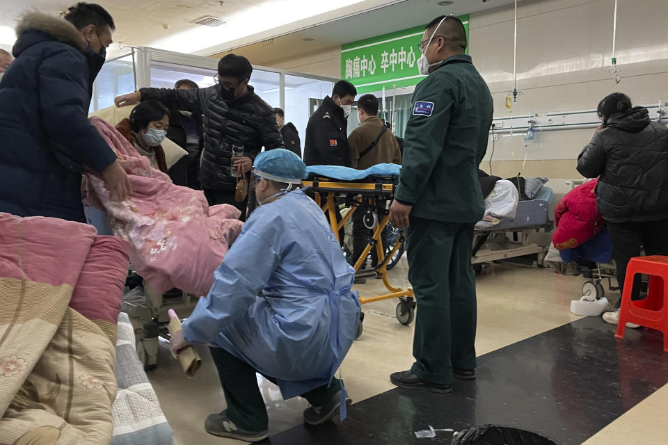 A sickened patient is moved onto a gurney at the emergency department of the Langfang No. 4 People's Hospital in Bazhou city in northern China's Hebei province on Thursday, Dec. 22, 2022. As China grapples with its first-ever wave of COVID mass infections, emergency wards in the towns and cities to Beijing's southwest are overwhelmed. Intensive care units are turning away ambulances, residents are driving sick relatives from hospital to hospital, and patients are lying on floors for a lack of space. (AP Photo)