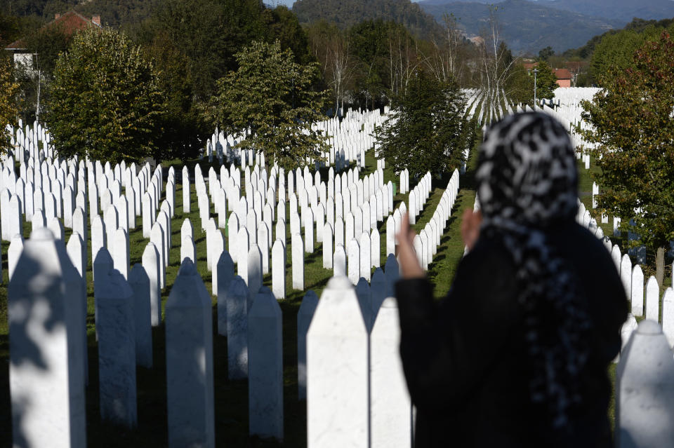 A woman prays at the memorial cemetery in Potocari, after the first public showing of Bosnian filmmaker Jasmila Zbanic's film on the 1995 massacre in Srebrenica - "Quo Vadis, Aida?", in the eastern Bosnian town of Srebrenica, Oct. 10, 2020. The Srebrenica massacre was the culmination of Bosnia's 1992-95 war, which pitted the country's three main ethnic factions - Serbs, Croats and Bosnian Muslims. (AP Photo/Kemal Softic)