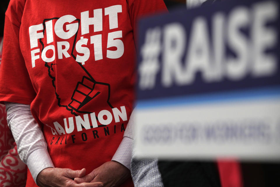 WASHINGTON, DC - JULY 18:  An activist wears a "Fight For $15" T-shirt during a news conference prior to a vote on the Raise the Wage Act July 18, 2019 at the U.S. Capitol in Washington, DC. The legislation would raise the federal minimum wage from $7.25 to $15 by 2025.  (Photo by Alex Wong/Getty Images)