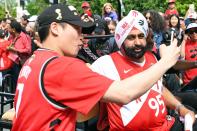 Toronto Raptors super fan Nav Bhatia celebrates with a fan during the Toronto Raptors Championship Parade on Lakeshore Boulevard. (Photo by Gerry Angus-USA TODAY Sports)