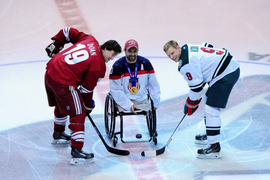 Paralympian and gold medal winner Josh Sweeney drops the puck for a ceremonial face off between Phoenix Coyotes right wing Shane Doan, left, and Minnesota Wild center Mikko Koivu prior to a game in 2014 in Glendale, Arizona. Matt Kartozian/USA TODAY NETWORK