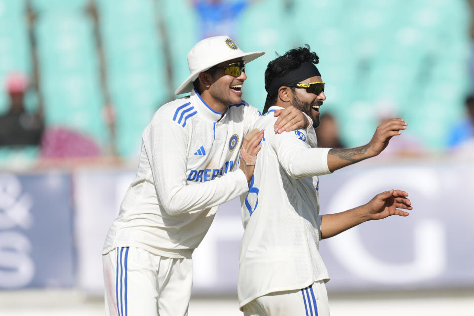 India's Ravindra Jadeja, right, and Shubman Gill celebrate the wicket of England's Ben Foakes on the fourth day of the third cricket test match between England and India in Rajkot, India, Sunday, Feb. 18, 2024. (AP Photo/Ajit Solanki)