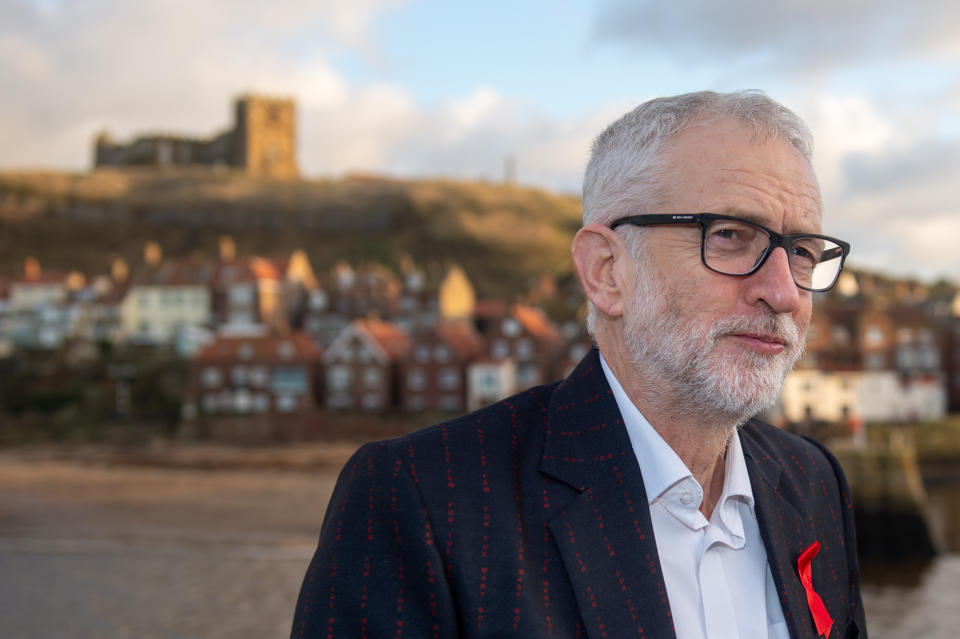 Labour leader Jeremy Corbyn wearing a jacket that has "for the many not the few" printed all over it, while on the General Election campaign trail in Whitby.