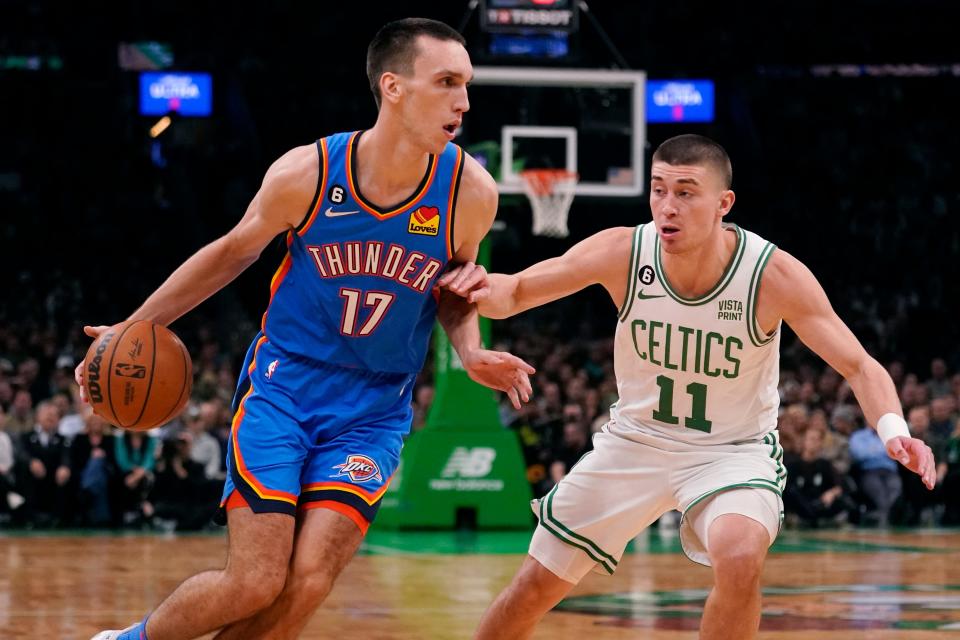 Oklahoma City Thunder forward Aleksej Pokusevski (17) drives against Boston Celtics guard Payton Pritchard (11) during the first half of an NBA basketball game, Monday, Nov. 14, 2022, in Boston. (AP Photo/Charles Krupa)