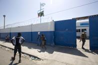 En esta fotografía del 16 de agosto de 2016, un cazco azul brasileño abre una puerta grande en una base de la ONU en el barrio pobre de Cite Soleil en Puerto Príncipe, Haití. Según una investigación de The Associated Press, unas 150 denuncias de abuso y explotación sexual fueron registradas en Haití de 2004 a 2016. Las denuncian implicaban a cascos azules y otro personal de la ONU. Los victimarios son de Bangladesh, Brasil, Jordania, Nigeria, Pakistán, Uruguay y Sri Lanka, según información de la ONU y entrevistas. Otros países podrían estar implicados y la ONU comenzó a revelar las nacionalidades de los infractores después de 2015. (AP Foto/Dieu Nalio Chery)