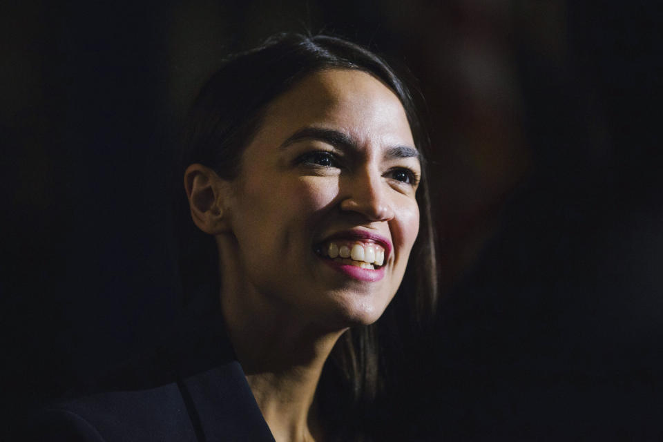 FILE - In this Saturday, Feb. 16, 2019 file photo, Rep. Alexandria Ocasio-Cortez, D-N.Y., delivers her inaugural address following her swearing-in ceremony at the Renaissance School for Musical Theater and Technology in the Bronx borough of New York. Democrats hoping to unseat President Donald Trump in 2020 are courting the party’s famous freshmen, including Ocasio-Cortez and those from early voting states such as New Hampshire, South Carolina and Iowa. (AP Photo/Kevin Hagen, File)