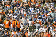 Dallas Cowboys and Denver Broncos fans watch NFL football practice Thursday, Aug. 11, 2022, at the Denver Broncos' headquarters in Centennial, Colo. (AP Photo/David Zalubowski)