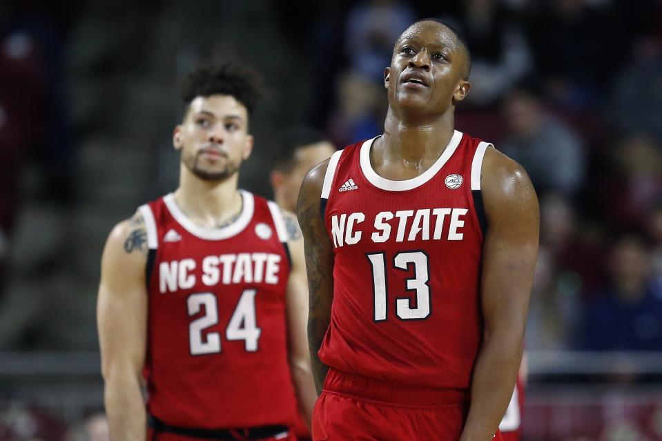 North Carolina State's C.J. Bryce (13) and Devon Daniels (24) react during the second half of an NCAA college basketball game against Boston College in Boston, Sunday, Feb. 16, 2020. (AP Photo/Michael Dwyer)