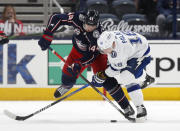 Columbus Blue Jackets defenseman Vladislav Gavrikov, left, and Tampa Bay Lightning forward Ondrej Palat work for the puck during the second period of an NHL hockey game in Columbus, Ohio, Thursday, April 8, 2021. (AP Photo/Paul Vernon)