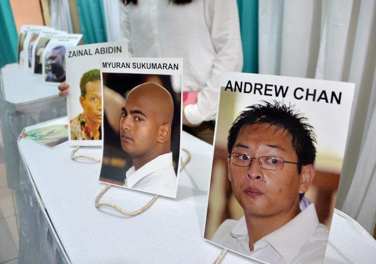 Photographs of executed drug convicts are displayed at a hospital morgue in Jakarta on April 29, 2015 during a prayer session
