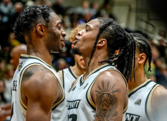 Bryant's Earl Timberlake, left, celebrates with teammate Kyonn Cramer after drawing a foul on a New Hampshire player during Saturday afternoon's America East game.