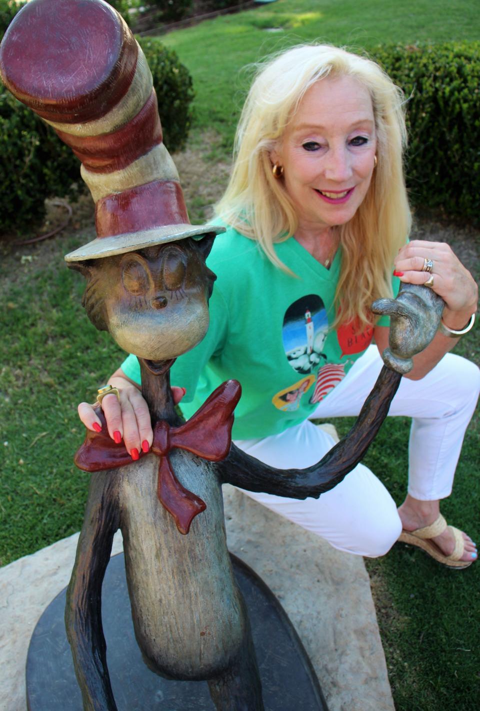 Lynn Barnett, Abilene Cultural Affairs Council director, with the Cat in the Hat Tuesday, the first storybook sculpture purchased or commissioned related to the annual Children's Art & Literacy Festival.
