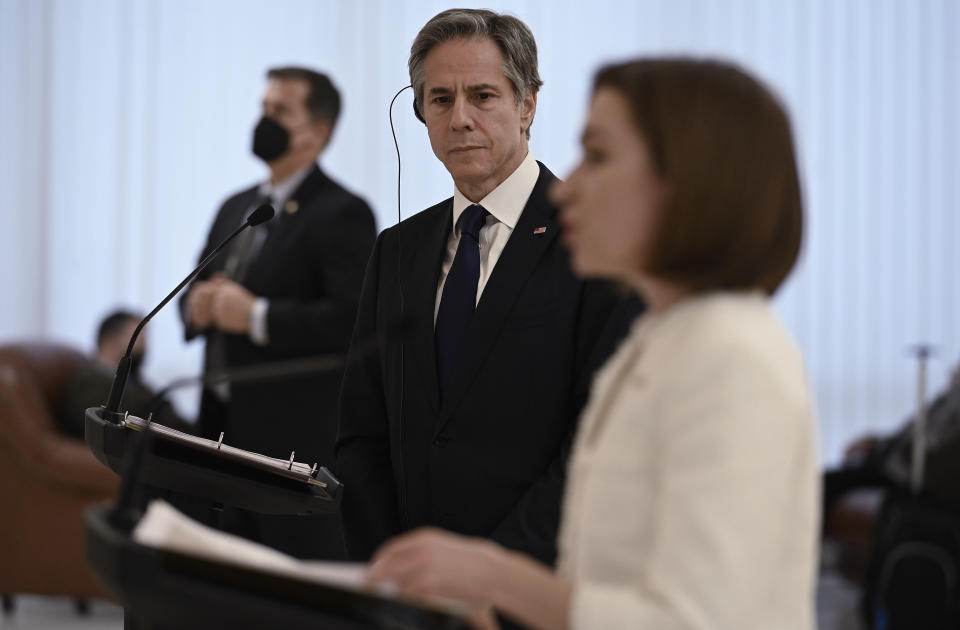 US Secretary of State Antony Blinken background, centre, listens as Moldova's President Maia Sandu speaks following their talks, at the Presidential Palace, in Chisinau, Moldova, Sunday, March 6, 2022. Blinken is in Moldova pledging America’s support to the small Western-leaning former Soviet republic that is coping with an influx of refugees from Ukraine and warily watching Russia’s intensifying war with its neighbor. (Olivier Douliery/Pool Photo via AP)