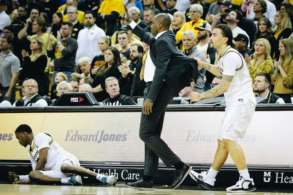 Missouri guard Tre Gomillion (right) holds MU head coach Dennis Gates back during the Tigers' Border War game against Kansas on Dec. 10, 2022, at Mizzou Arena in Columbia, Mo. The Jayhawks' 95-67 win was the first loss in Gates' tenure.