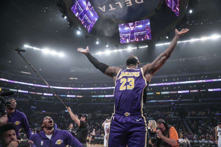 LOS ANGELES, CA, WEDNESDAY, JANUARY 15, 2020 - Los Angeles Lakers forward LeBron James (23) tosses talcum powder as teammates Dwight Howard, Quinn Cook and Kentavious Caldwell Pope against the Orlando Magic at Staples Center. (Robert Gauthier/Los Angeles Times)