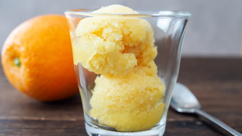 Glass filled with scoops of orange sorbet
