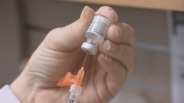 A pharmacist draws a dose of COVID-19 vaccine. (CBC - image credit)