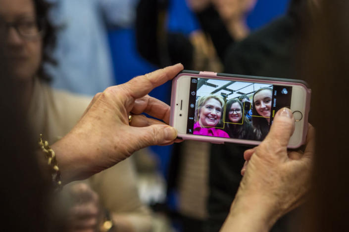 <p>Democratic presidential candidate Hillary Clinton is seen on a cellphone screen taking a selfie with audience members following a campaign organizing event at Eagle Heights Elementary on Jan. 23, 2016 in Clinton, Iowa. (Photo: Brendan Hoffman/Getty Images)</p>