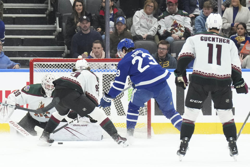 Toronto Maple Leafs' Matthew Knies (23) scores against Arizona Coyotes goaltender Connor Ingram, left, during first-period NHL hockey game action in Toronto, Thursday, Feb. 29, 2024. (Chris Young/The Canadian Press via AP)