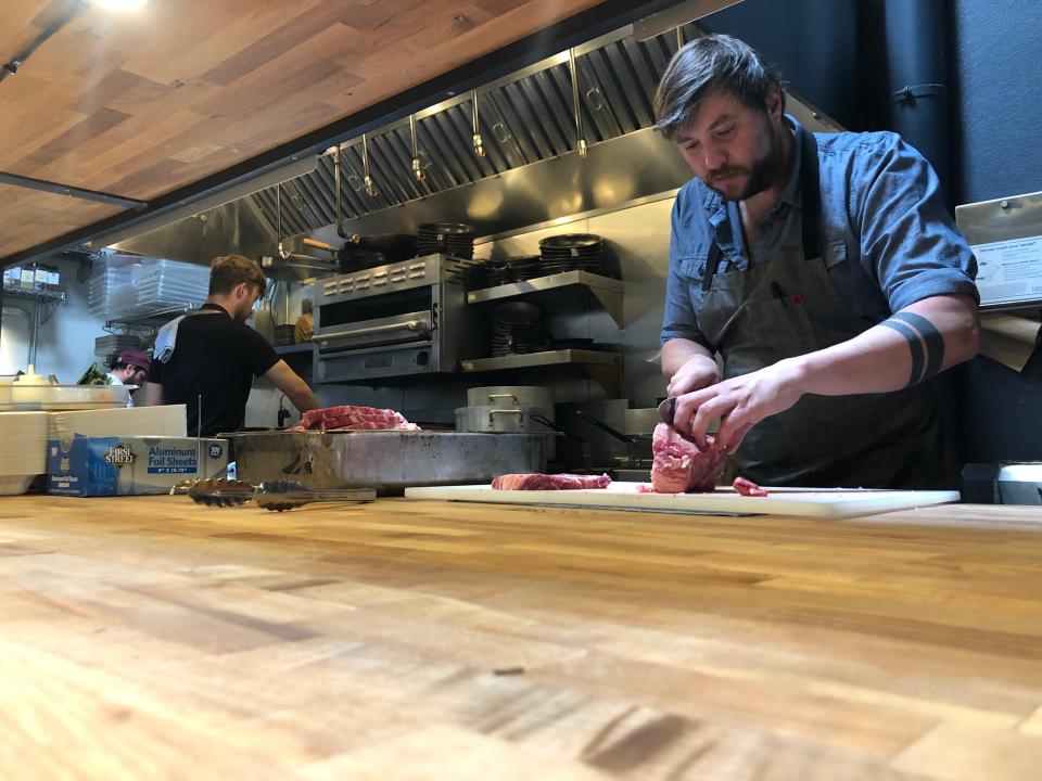Portland chef Ryley Eckersley, whose restaurant Quaintrelle has shifted to takeout only, preps chicken fried steak in his small kitchen, where he says it's nearly impossible to stay 6 feet away from his cooks.