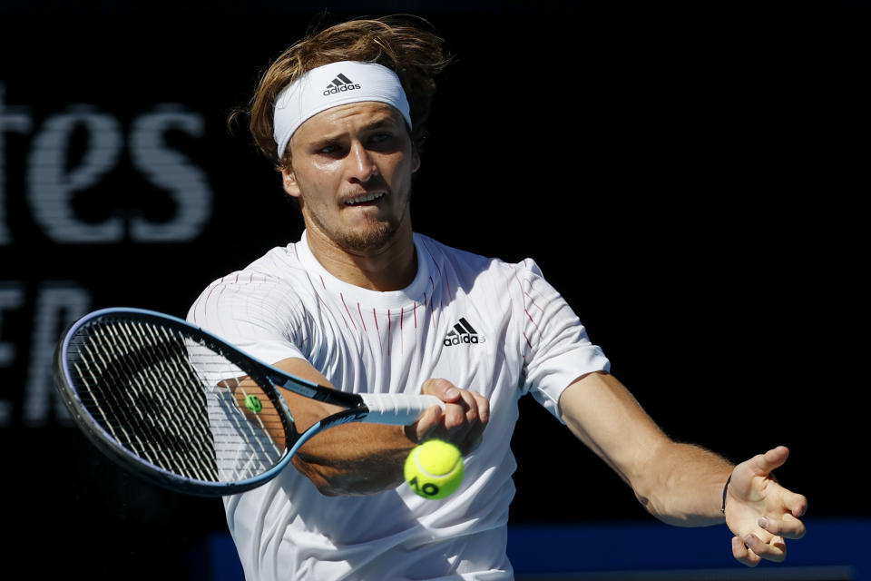 Alexander Zverev of Germany makes a forehand return to Denis Shapovalov of Canada during their fourth round match at the Australian Open tennis championships in Melbourne, Australia, Sunday, Jan. 23, 2022. (AP Photo/Tertius Pickard)