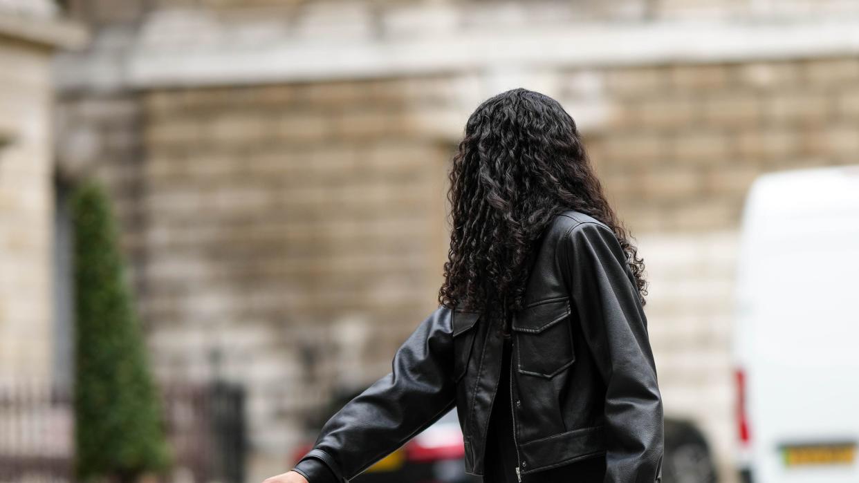 a model with a luggage set at street style lfw february 2023