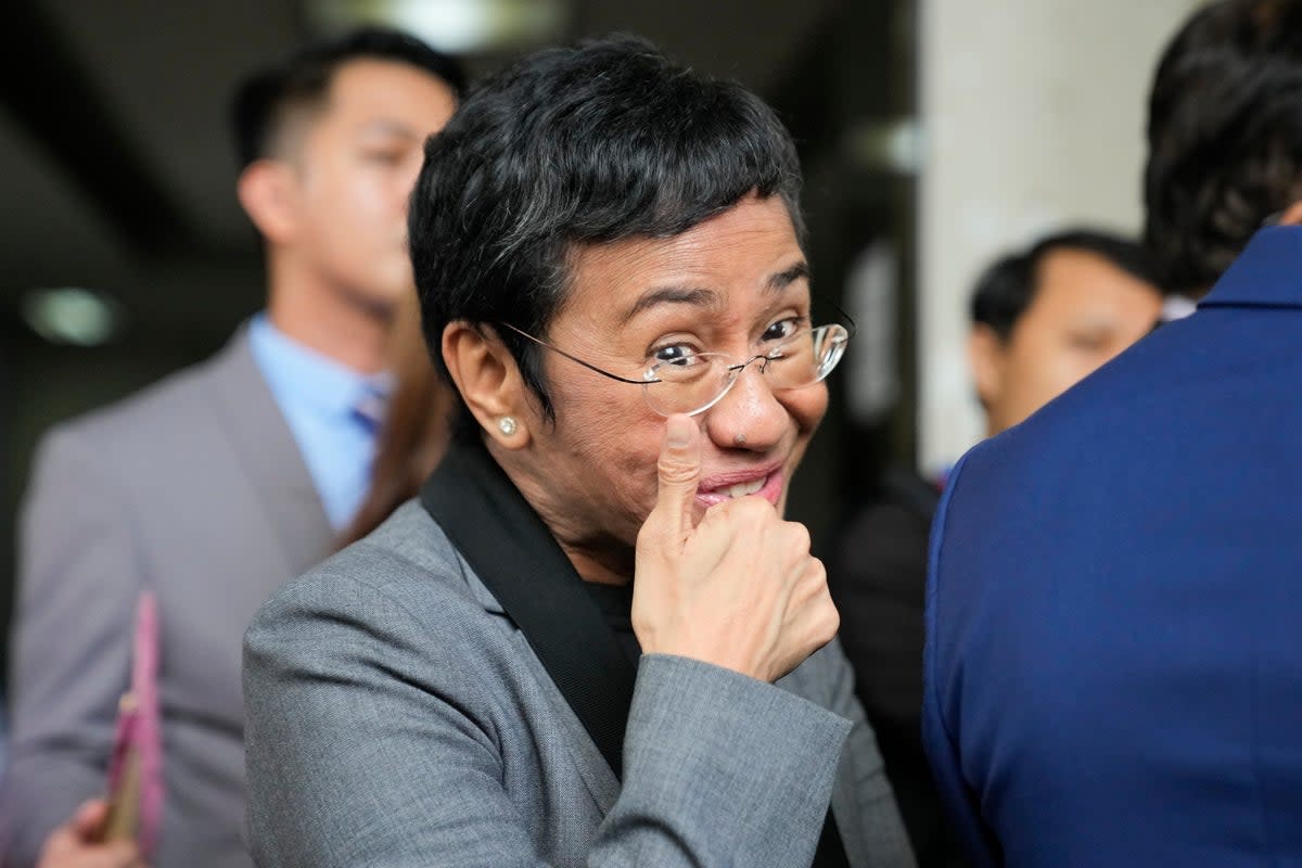 Filipino journalist Maria Ressa, 2021 Nobel Peace Prize winner and Rappler CEO, gestures as she talks to reporters after being acquitted by the Pasig Regional Trial Court over a tax evasion case in Pasig city, Philippines on Tuesday, 12 September 2023 (Associated Press)