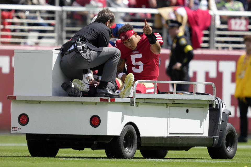 San Francisco 49ers quarterback Trey Lance (5) gestures while being carted off the field during the first half of an NFL football game against the Seattle Seahawks in Santa Clara, Calif., Sunday, Sept. 18, 2022. (AP Photo/Tony Avelar)