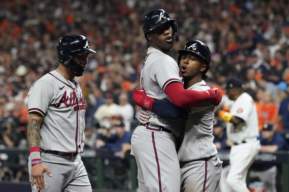 Atlanta Braves' Jorge Soler celebrates a three-run home run with Ozzie Albies during the third inning in Game 6 of baseball's World Series between the Houston Astros and the Atlanta Braves Tuesday, Nov. 2, 2021, in Houston. (AP Photo/Eric Gay)