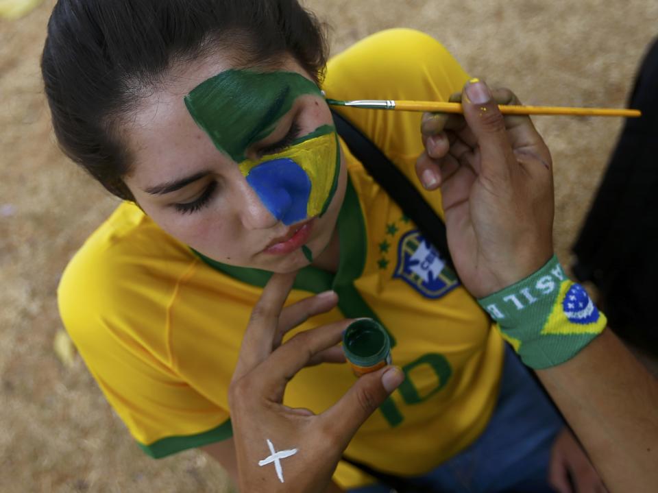 A fan arrives for the World Cup semi-final match Brazil against Germany ouside Estadio Mineirao in Belo Horizonte