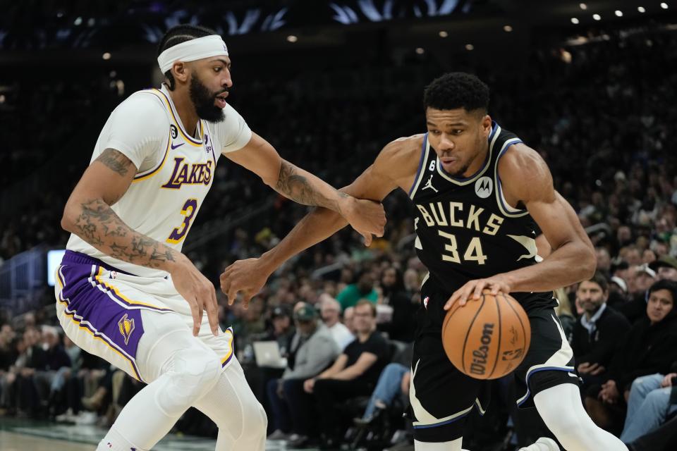 Milwaukee Bucks' Giannis Antetokounmpo drives past Los Angeles Lakers' Anthony Davis during the first half of an NBA basketball game Friday, Dec. 2, 2022, in Milwaukee. (AP Photo/Morry Gash)