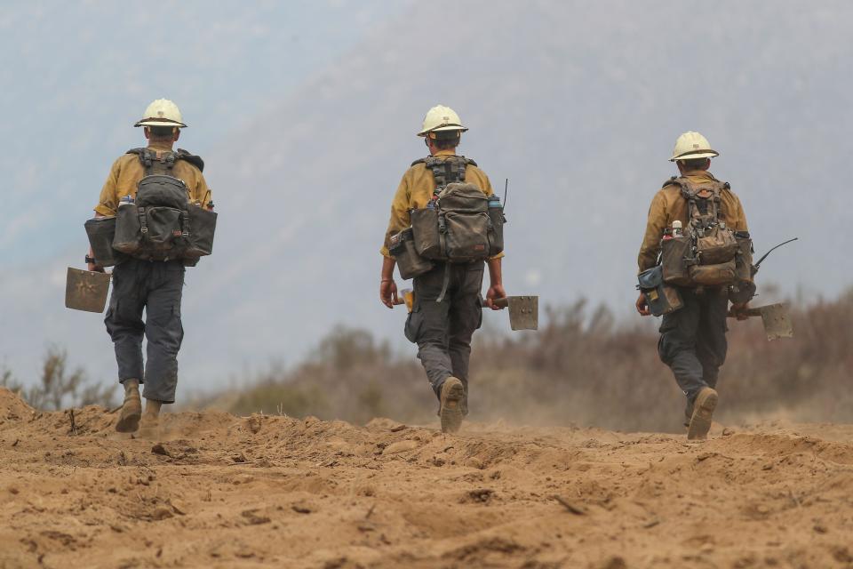 A hand crew works the Fairview Fire in a remote area south of Hwy 74 in the Cleveland National Forest, Sept. 8, 2022.