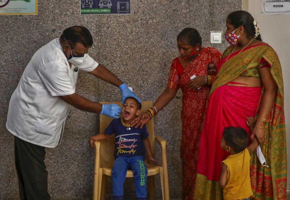 A health worker takes a mouth swab