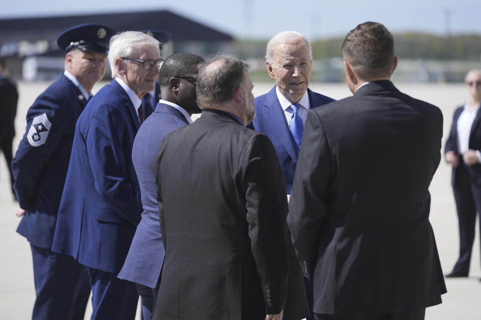 President Joe Biden is greeted by Wisconsin Gov. Tony Evers, Racine Mayor Cory Mason, Milwaukee County Executive David Crowley, and Racine County Executive Jonathan Delagrave, as he arrives at Milwaukee Mitchell International Airport, Wednesday, May 8, 2024, in Milwaukee. (AP Photo/Evan Vucci)