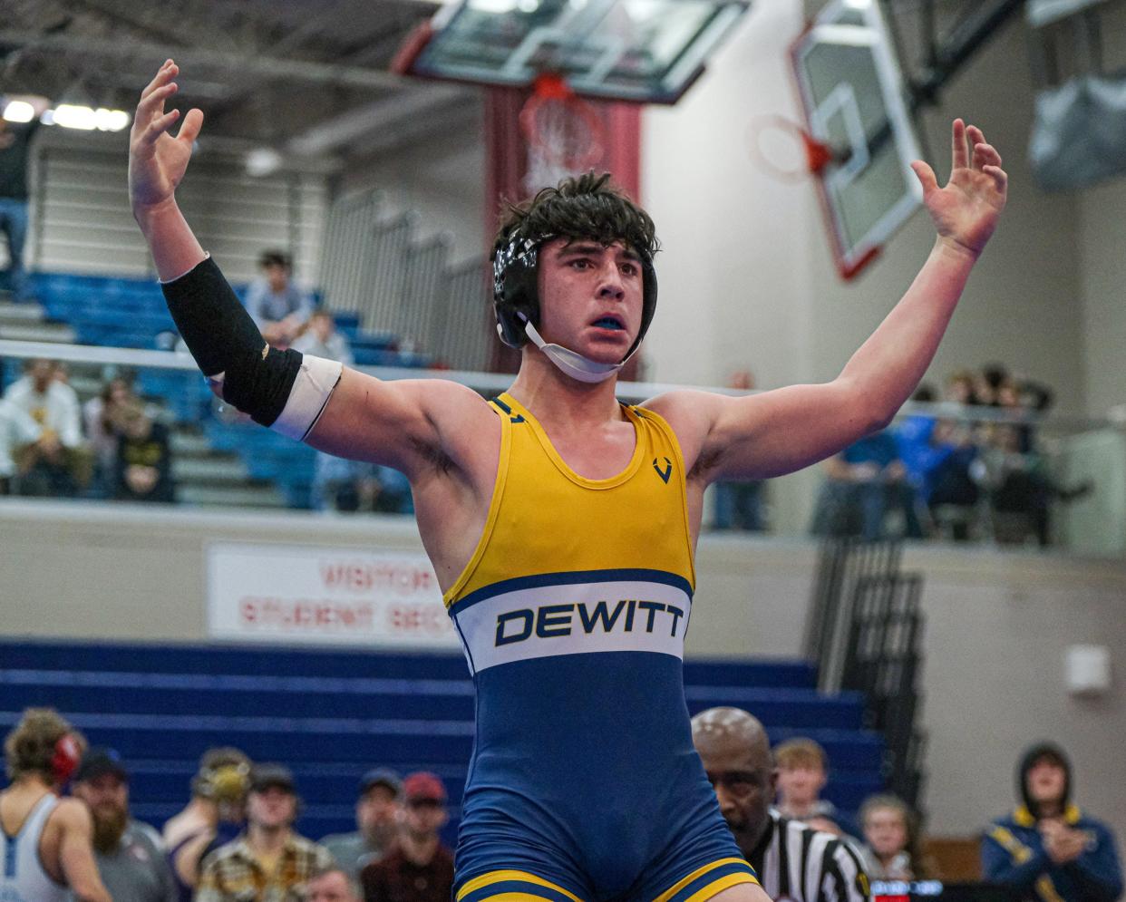 Tyler Bashore from DeWitt celebrates his win in the 150 weight class at the CAAC Wrestling Championships Saturday, Feb. 3, 2024.