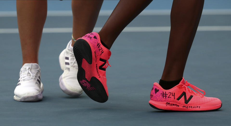 United States' Coco Gauff, right, and compatriot Caty McNally wear a tribute to Kobe Bryant on their shoes during their doubles match against Japan's Shuko Aoyama amd Ena Shibahara at the Australian Open tennis championship in Melbourne, Australia, Monday, Jan. 27, 2020. (AP Photo/Dita Alangkara)