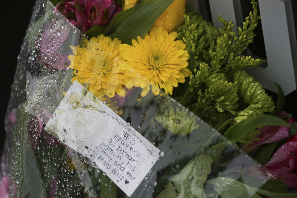 Flowers and a card showing support for Buffalo Bills NFL football safety Damar Hamlin sit outside Highmark Stadium Wednesday, Jan. 4, 2023, in Orchard Park, N.Y. (AP Photo/Joshua Bessex)