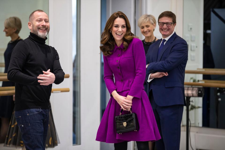 The Duchess of Cambridge went all out for the occasion, pairing her magenta top and skirt with an $888 tote croc pattern handbag from Aspinal. Photo: Getty Images