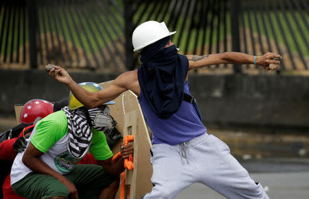 Demonstrators clash with riot security forces while rallying against Venezuela's President Nicolas Maduro in Caracas, Venezuela. REUTERS/Marco Bello