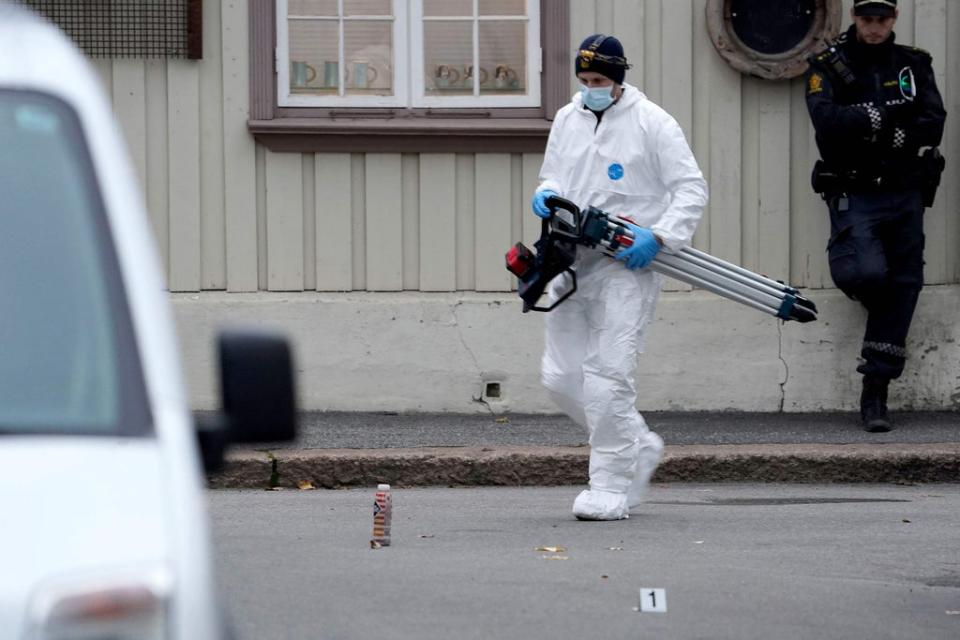 A police forensic officer carries material during investigations after the shootings (NTB/AFP via Getty Images)