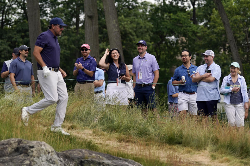 Fans cheer for Phil Mickelson on his way to the 12th hole during the second round of the U.S. Open golf tournament at The Country Club, Friday, June 17, 2022, in Brookline, Mass. (AP Photo/Robert F. Bukaty)