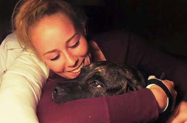 Bethany Stephens cuddles Tonka as a puppy. Source: Supplied