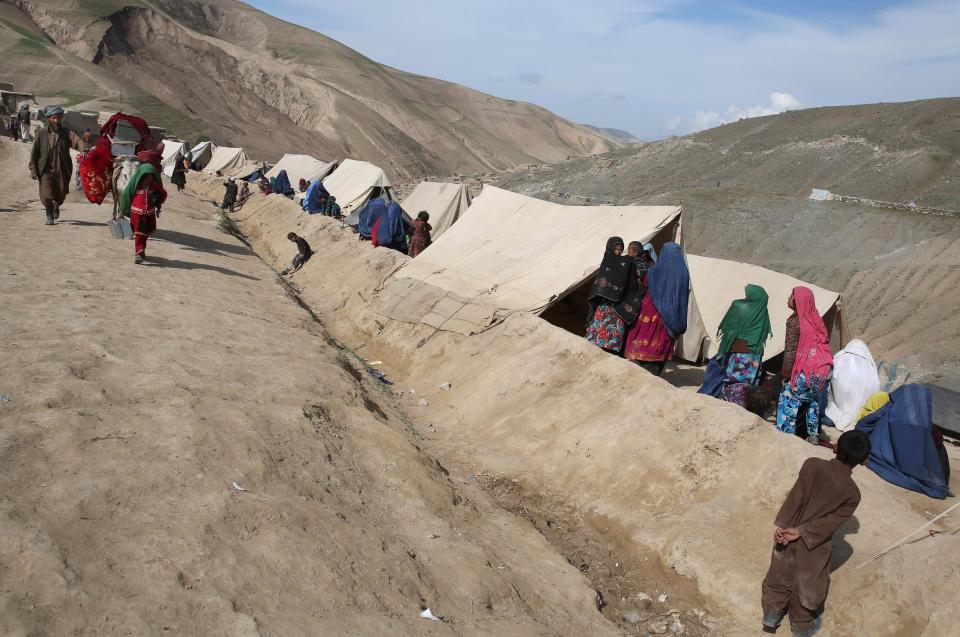 Survivors stay in their tent near the site of Friday's landslide that buried Abi-Barik village in Badakhshan province, northeastern Afghanistan, Tuesday, May 6, 2014. Authorities tried to help families displaced by the torrent of mud that swept through Abi-Barik village after hundreds were killed. (AP Photo/Massoud Hossaini)