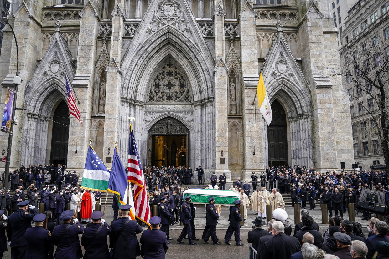 Image: New York Police pall bearers carry the casket of Officer Wilbert Mora to a hearse following Mora's funeral service at St. Patrick's Cathedral on Feb. 2, 2022, in New York. (John Minchillo / AP)