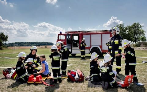 The all-girl young volunteer firefighters team in the village of Miejsce Odrzanskie, Poland, - Credit: Kasia Strek/NYTNS / Redux / eyevine&nbsp;