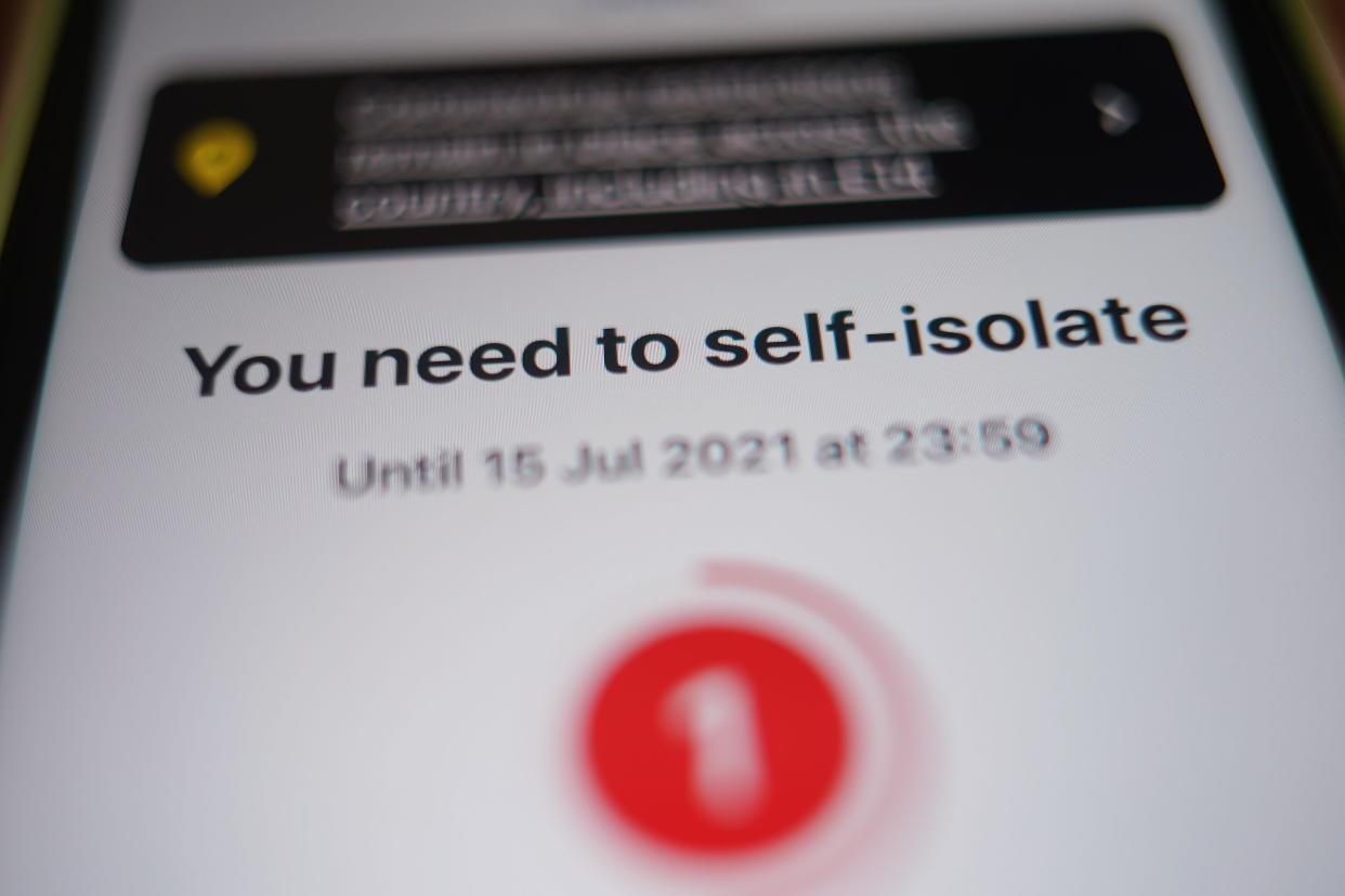 A message to self-isolate, with one day of required isolation remaining, is displayed on the NHS coronavirus contact tracing app on a mobile phone, in London. Picture date: Thursday July 15, 2021. (Photo by Yui Mok/PA Images via Getty Images)