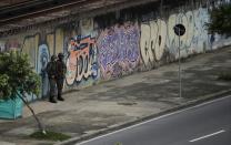 <p>Soldiers stand guard across the street from Maracana stadium, shortly before the closing ceremony for the Summer Olympics in Rio de Janeiro, Brazil, Sunday, Aug. 21, 2016. (AP Photo/Charlie Riedel) </p>